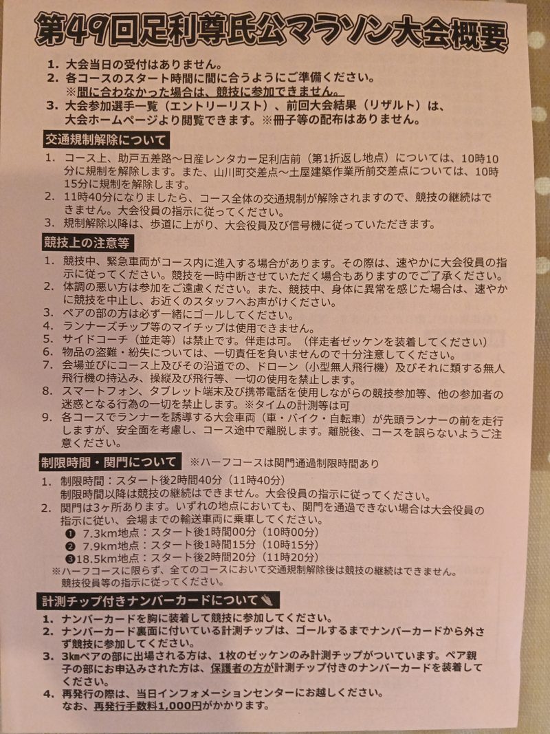 第49回足利尊氏公マラソン大会概要の紙。交通規制の解除、競技上の注意、制限時間と関門、計測チップ付きナンバーカードについて書かれている
